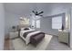 Serene main bedroom featuring a plush bed, neutral tones, a ceiling fan, and ample natural light at 840 Sheerwater Ave, Henderson, NV 89052