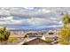 Neighborhood view shows mountains in the distance, neighborhood roofs, and cloudy skies overhead at 840 Sheerwater Ave, Henderson, NV 89052