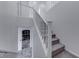 Carpeted staircase with white railings and a view of the kitchen at 840 Sheerwater Ave, Henderson, NV 89052