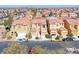 Street view capturing a row of homes, showcasing architectural styles and neighborhood character with parked vehicles at 840 Sheerwater Ave, Henderson, NV 89052