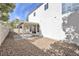 A backyard showcasing a covered patio area, desert landscaping, and neutral colors at 8979 Green Jade Dr, Las Vegas, NV 89129