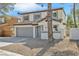 Two-story home with gray garage door and desert landscaping at 8979 Green Jade Dr, Las Vegas, NV 89129