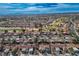 Wide aerial view of a community featuring well-maintained homes, trees, and a golf course at 9001 Marble Dr, Las Vegas, NV 89134