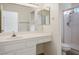 Clean bathroom featuring white vanity with sink, a large mirror and a shower with glass door at 9001 Marble Dr, Las Vegas, NV 89134