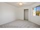 Clean bedroom with neutral carpet, closet, ceiling fan, and window at 9001 Marble Dr, Las Vegas, NV 89134