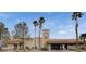 Fitness center building with a clock tower, mature palm trees, and well-maintained landscaping at 9001 Marble Dr, Las Vegas, NV 89134