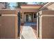 The front entrance features a gated front porch and beautiful stone pillars along the walkway at 9001 Marble Dr, Las Vegas, NV 89134