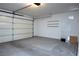 Spacious garage with an automatic door, concrete flooring, and additional storage shelves at 9001 Marble Dr, Las Vegas, NV 89134