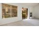 Living room featuring neutral carpet, large window and glass door with backyard views, and fireplace at 9001 Marble Dr, Las Vegas, NV 89134