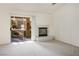 The bright living room features a fireplace, carpeting, and sliding door access to the back patio at 9001 Marble Dr, Las Vegas, NV 89134