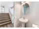 Bathroom featuring a single vanity with a white sink and a stairway nearby at 9124 Palatial Palette Ct, Las Vegas, NV 89149