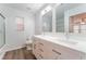 Bright bathroom featuring double vanity, white cabinets, and modern fixtures at 9124 Palatial Palette Ct, Las Vegas, NV 89149