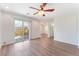 Bedroom showcasing wood floors, ceiling fan, and sliding glass door at 9124 Palatial Palette Ct, Las Vegas, NV 89149