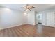 Spacious primary bedroom with wood flooring, ceiling fan, and ensuite bathroom access at 9124 Palatial Palette Ct, Las Vegas, NV 89149