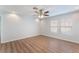 Sunny secondary bedroom featuring wood floors, neutral paint, and double pane windows at 9124 Palatial Palette Ct, Las Vegas, NV 89149