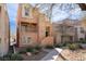 Inviting three-story home featuring balconies, stucco exterior, and well-kept front yard at 9124 Palatial Palette Ct, Las Vegas, NV 89149