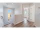 Bright upper-level hallway with hardwood floors and an arched window overlooking the street at 9124 Palatial Palette Ct, Las Vegas, NV 89149