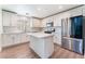 Bright kitchen featuring stainless steel appliances, an island, and ample counter space at 9124 Palatial Palette Ct, Las Vegas, NV 89149