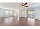 Bright living room features wood floors, ceiling fan, and sliding glass door to balcony at 9124 Palatial Palette Ct, Las Vegas, NV 89149