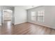 Bright living room featuring wood floors, neutral walls, and views to adjacent room at 9124 Palatial Palette Ct, Las Vegas, NV 89149