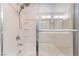 Shower featuring a glass door, tile surround, and a shower head with multiple settings at 9124 Palatial Palette Ct, Las Vegas, NV 89149