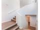 A well-lit staircase with wood flooring and white walls offers access to upper floors at 9124 Palatial Palette Ct, Las Vegas, NV 89149