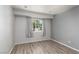 Bright bedroom features wood-look flooring, neutral walls, and a window with natural light at 924 Angel Star Ln, Las Vegas, NV 89145