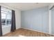 Cozy bedroom featuring a large window that fills the space with natural light, and wood-look flooring at 924 Angel Star Ln, Las Vegas, NV 89145