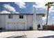 View of a home featuring a two-car garage, two chimneys, and a side gate at 924 Angel Star Ln, Las Vegas, NV 89145