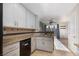 This kitchen offers granite countertops and white cabinetry, seamlessly connecting to the dining area at 924 Angel Star Ln, Las Vegas, NV 89145