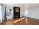 Living room with a sleek fireplace, hardwood floors and a large arched window at 924 Angel Star Ln, Las Vegas, NV 89145