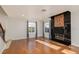 Living room with a modern fireplace, two large windows, and neutral wall color at 924 Angel Star Ln, Las Vegas, NV 89145