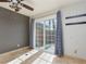 Bright living room with a ceiling fan and sliding glass doors to the outside patio at 924 Angel Star Ln, Las Vegas, NV 89145