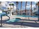 Resort-style pool area with spa and clear blue water, surrounded by palm trees at 924 Angel Star Ln, Las Vegas, NV 89145