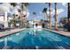 Relaxing pool area with clear blue water and lush palm trees at 924 Angel Star Ln, Las Vegas, NV 89145