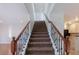 Staircase with wood handrail and black iron spindles leading to the upper level at 924 Angel Star Ln, Las Vegas, NV 89145