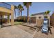 Backyard featuring mature palm trees, a playset, and artificial turf, ideal for and outdoor entertaining at 9379 Arrowhead Bluff Ave, Las Vegas, NV 89149