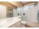 Well-lit bathroom featuring a vanity with white cabinetry and a shower-tub with glass doors at 9379 Arrowhead Bluff Ave, Las Vegas, NV 89149