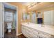 Bathroom featuring double vanity sinks, framed mirrors, and neutral paint at 9379 Arrowhead Bluff Ave, Las Vegas, NV 89149