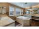 Bright bathroom featuring a corner tub and dual sinks at 9379 Arrowhead Bluff Ave, Las Vegas, NV 89149