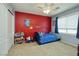 Colorful bedroom with bright accent wall, ceiling fan and a closet at 9379 Arrowhead Bluff Ave, Las Vegas, NV 89149