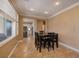 Cozy dining area features stylish table setting, tiled flooring, and a glimpse into the bright kitchen at 9379 Arrowhead Bluff Ave, Las Vegas, NV 89149