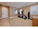 Well-lit exercise room with essential workout equipment and neutral-toned walls for a calming fitness space at 9379 Arrowhead Bluff Ave, Las Vegas, NV 89149