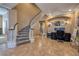 Grand foyer with a curved staircase, tile flooring, and ample space for a home office at 9379 Arrowhead Bluff Ave, Las Vegas, NV 89149