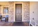 Charming front porch with stone accents, comfortable seating, and a welcoming entrance at 9379 Arrowhead Bluff Ave, Las Vegas, NV 89149