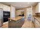 Stylish kitchen island complements stainless steel appliances, cabinets, and tile floor for seamless modern living at 9379 Arrowhead Bluff Ave, Las Vegas, NV 89149