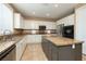 Bright kitchen features stainless steel appliances, center island, tile backsplash, and ample counter space at 9379 Arrowhead Bluff Ave, Las Vegas, NV 89149