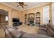 Inviting living room showcases built-in shelving, media setup, comfortable seating, and a warm ambiance at 9379 Arrowhead Bluff Ave, Las Vegas, NV 89149