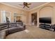 Open-concept living room boasts an entertainment center, neutral palette, and seamless flow to dining area at 9379 Arrowhead Bluff Ave, Las Vegas, NV 89149