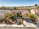 Aerial view of a charming single-story home with a tile roof and lush landscaping at 9809 Gerald Ct, Las Vegas, NV 89134